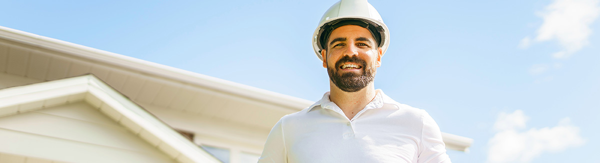 Contractor in front of house